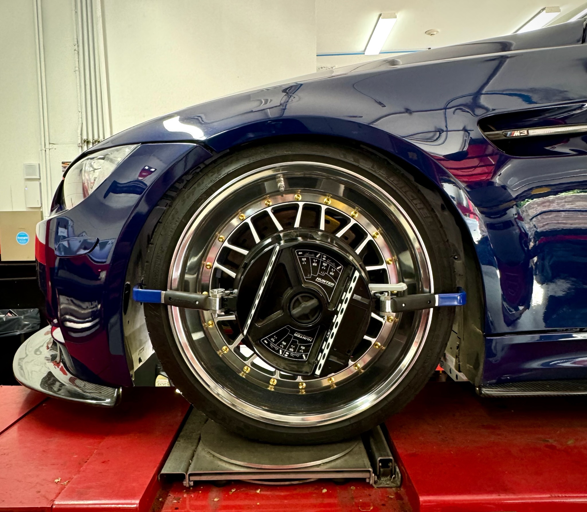 BMW receiving wheel alignment service from W12 Garage on a Hunter Wheel Alignment machine.